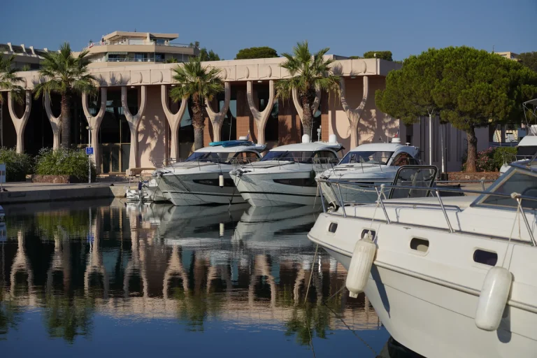 Bateaux à moteur amarrés à quai devant un bâtiment à colonnes du port Santa Lucia
